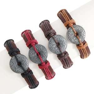 Four-piece set of woven leather bracelets with vintage ethnic style metal ornaments