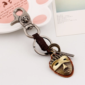 Vintage leather keychain with silver lobster clasp and ethnic tribal mask pendant