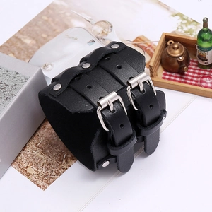 Detail of wide punk leather bracelet with double silver buckles and metal studs