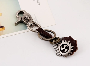 Close-up of punk style leather braided keychain with skull alloy buckle and vintage gear