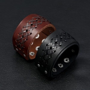 Macro shot of multi-layer woven leather bracelets in black and brown with metal buckles