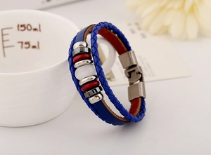 Macro view of blue woven leather bracelet with wooden beads and a white cat-eye stone