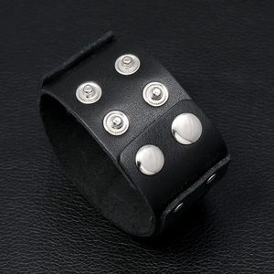 Macro detail of black braided leather punk bracelet with adjustable silver metal snaps