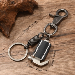 Retro punk leather keychain with hammer pendant and dimensions shown on wood surface