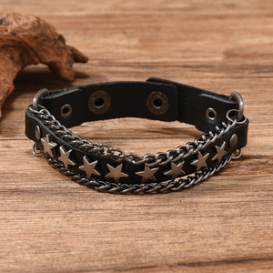 Close-up of punk leather bracelet with star studs and double chain details