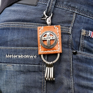 Vintage brown leather keychain with cross ichthys silver medallion and hook on jeans