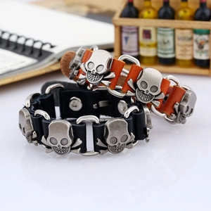 Punk style leather bracelets with skull charms in black and brown finishes