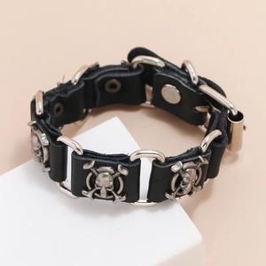 Punk rock men's black leather bracelet featuring silver metal skull crossbones charms