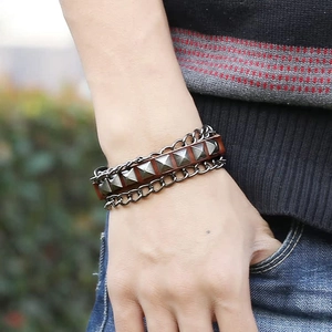Punk brown leather bracelet featuring pyramid studs and double black metal chains
