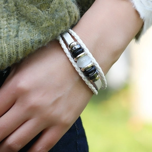 White multi-layer braided leather bracelet with beads and cat eye stone on wrist