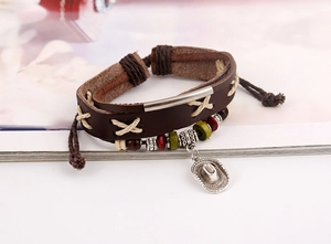 Detail of multi-layer leather bracelet with beaded wood accents and silver hat charm