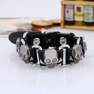 Detail of punk skull leather bracelet with silver metallic skull charms and ring links