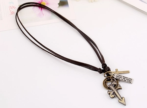 Detail of vintage punk leather necklace featuring cross charms and bronze metal rings