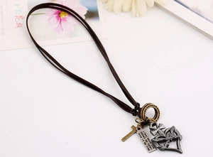 Detail of vintage punk leather necklace featuring bronze cross and heart charms