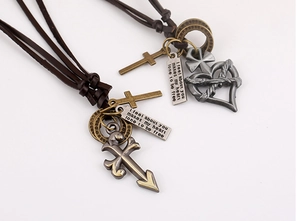 Close-up of vintage rock leather necklaces with heart pendants and engraved metal tags