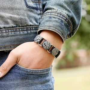 Retro punk genuine leather bracelet with floral relief metal buckle worn by male model