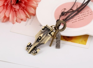Macro detail of bronze F1 race car pendant and engraved tag on leather cord necklace