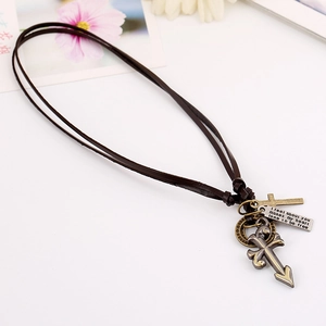 Vintage dark brown leather necklace with cross pendants and engraved plaque on white background