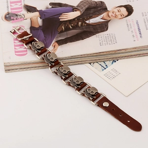 Men's punk leather bracelet featuring five vintage silver skull charms and metal buckle