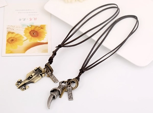 Close-up of vintage punk leather necklaces featuring F1 car and dragon claw alloy pendants