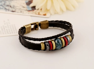 Detail of bohemian multilayer leather bracelet with ceramic beads and metal clasp
