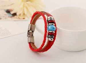 Detail of red leather woven bracelet with blue beads and vintage metal clasp