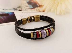 Close-up of vintage multi-layer leather braided bracelet with bronze alloy beads and magnetic stones