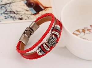 Detail of red multilayer leather bracelet featuring a vintage silver star cross charm