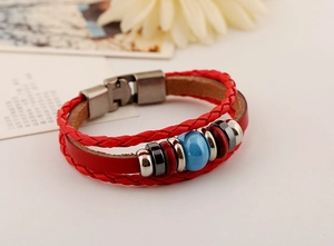 Detail of red multilayer leather bracelet with blue stone bead and vintage metal clasp