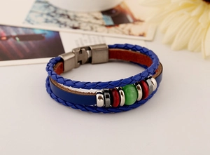 Close-up of royal blue braided leather bracelet with vintage silver beads and stones