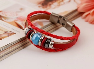 Macro shot of red multilayer braided leather bracelet with blue beads and silver clasp