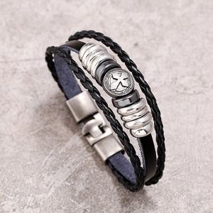 Detail view of multi-layer black leather bracelet with silver cross bead and metal spacers