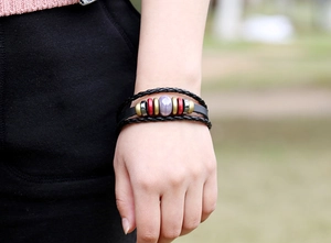 Detail of multi-layer leather braided bracelet with purple crystal and colorful beads