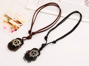 Close-up of vintage rock style leather necklaces with gear sun totem metal pendants