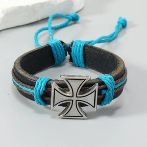 Detail of hand-woven leather bracelet with silver iron cross and blue cord accents