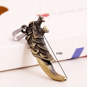 Macro detail of bronze dragon head ivory pendant with dimensions 40x12mm on white box