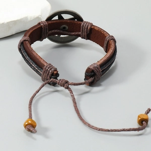 Detail view of woven leather bracelet with star charm and adjustable beaded drawstring