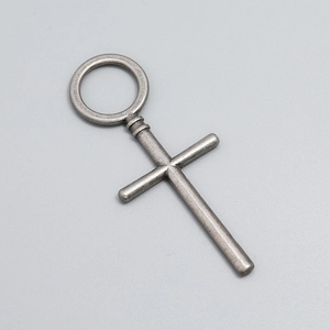Detailed view of vintage silver cross pendant with antique finish for jewelry making