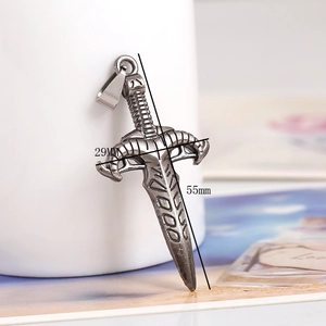Detail view of vintage alloy dagger pendant with 55mm height and 29mm width dimensions