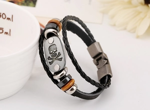 Detailed macro view of punk multilayer leather bracelet with skull metal charm and beads