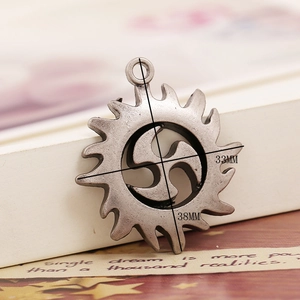 Detailed view of antique silver alloy gear pendant with triskelion symbol and dimensions
