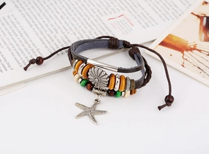 Close-up of bohemian leather bracelet with colorful wood beads and starfish charm
