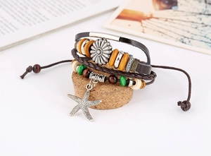 Detail view of multi-layer leather bracelet with sunflower charm and starfish pendant