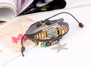Macro view of multi-layer leather bracelet with metal sunflower and starfish charms