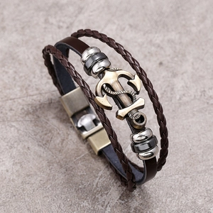 Detail view of multi-layer woven leather anchor bracelet with vintage bronze clasp