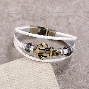 Detail of nautical multi-layer braided leather bracelet with bronze anchor charm and metal clasp