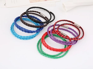 Detail view of colorful braided leather bracelets with silver metal magnetic clasps