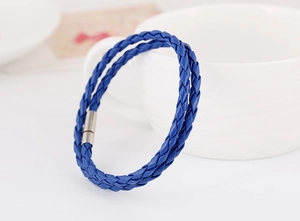 Detail view of dark blue woven leather bracelet with silver magnetic cylinder clasp