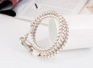 Close-up of white multi-layer woven leather bracelet with polished silver lobster clasp