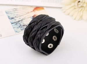 Detailed view of black multi-layer braided leather bracelet with silver snap buttons
